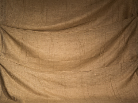 Old rustic hessian sacks draped together as a beautiful brown textured backdrop.の写真素材