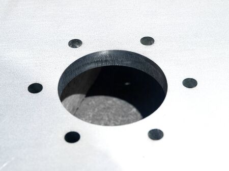 futuristic stainless steel metal, laser cutout on a rustic backgroundの写真素材