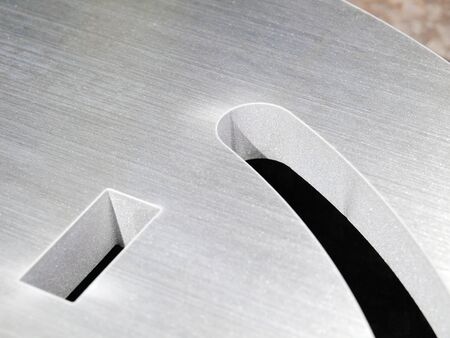 futuristic stainless steel metal, laser cutout on a rustic backgroundの写真素材