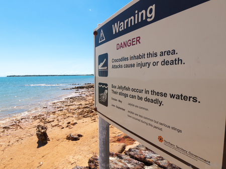 Darwin, Australia, 05/05/2016, A beautiful summers day on a beach in darwin Australia. A No swimming sign on the beach due to crocodiles and box jellyfish in the sea.のeditorial素材