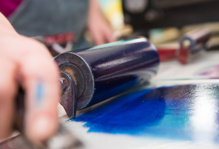 an acrylic paint roller for mono printing and screen printing, rolling paint ready for mono printing.の写真素材