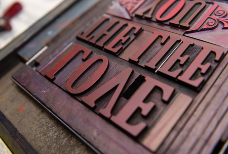 london, england, 05/05/2017 vintage wooden antique analogue typeset letter blocks being prepared for block printing.の写真素材