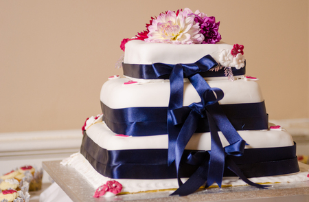 A beautiful sweet creamy Wedding cake with beautiful flowers and decorations, shot with a shallow depth of field.の写真素材