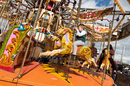 london, england, 02/02/2017 A retro colourful vintage horse carousel at a Fairground, with traditional festival vintage horses.のeditorial素材