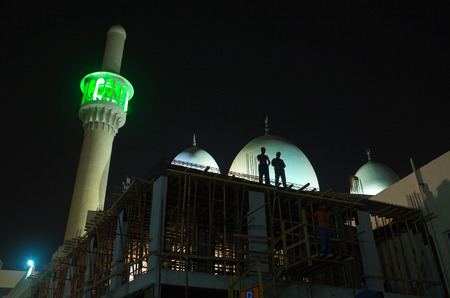 dubai, united arab emirates, 02/02/2017, indian and Pakistani Construction workers working on a mosque in bur dubai, deira in the evening cool air. dubai workers resting.のeditorial素材