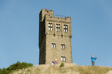 Huddersfield, England, 10/10/2017 Victoria tower, An ancient medieval castle at Castle Hill, against a vivid blue sky in Huddersfield Englandのeditorial素材