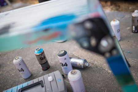 ulverston, England, 05/05/201, Empty graffiti spray cans at a public exhibition of legal graffiti and street art. Art in the town of ulverston. A live graffiti wall been spray painted.のeditorial素材
