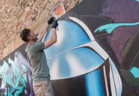 ulverston, England, 05/05/201, A graffiti artist working at a public exhibition of legal graffiti and street art. Art in the town of ulverston. A live graffiti wall been spray painted.のeditorial素材