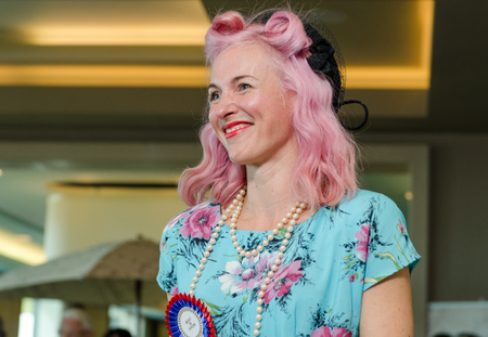 london, England, 05/05/2017, A stylish retro vintage fashionable beautiful woman with bright pink hair and a blue floral outfit in a Best dressed award at a vintage event..のeditorial素材