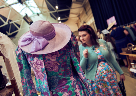 london, england, 05/05/2017 Vintage second hand pink lilac hat and clothes rail showing colourful vintage clothes on coat hangers, at a vintage fair.のeditorial素材