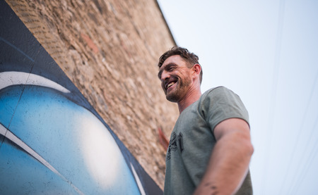 ulverston, England, 05/05/201, A graffiti artist working at a public exhibition of legal graffiti and street art. Art in the town of ulverston. A live graffiti wall been spray painted.のeditorial素材