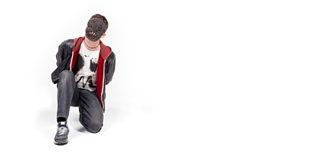 A man wearing a scary mask, photographed against a white infinity curve background in a studio. A...