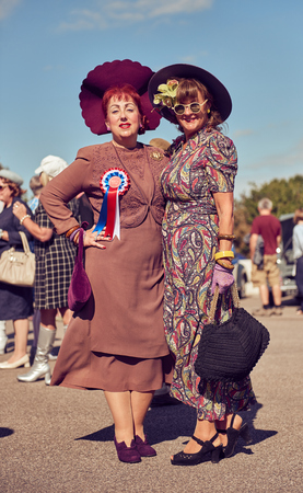 morecambe, England, 05/05/2017, A pair of stylish retro vintage fashionable women in hats acting and posing in fancy dress cosplay in a Best dressed award at a vintage event at the Midland hotel.のeditorial素材