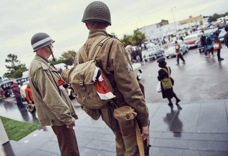 london, England, 05/05/2017, A stylish retro vintage world war two ww2 war veteran in soldier fancy dress uniform with a machine gun weapon. Best dressed award at a vintage nostalgic 1940's event. のeditorial素材