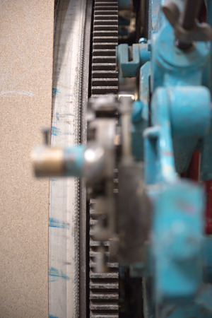 Beautiful metal industrial machinery steel cogs in a rustic industrial factory setting. Well used processing machinery parts.の写真素材