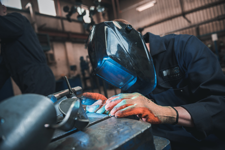 london, england, 02/02/2018 A vibrant action shot of a skilled working metal welder in action,...