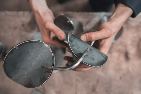 Industrial laser cut steel metal pieces in a cold hard industrial factory setting. Metal iron cut pieces being prepared for manufacture.の写真素材