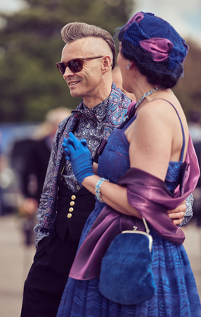 london, England, 05/05/2017, A stylish retro vintage fashionable couple in a blue blazer, hipster hair mohawk, straw bowler hat and walking cane at a vintage event at the midland hotel.のeditorial素材
