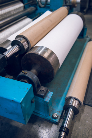 An empty quiet industrial wallpaper and paint factory with giant industrial wall paper rolling...