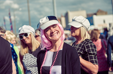 london, England, 05/05/2017, A stylish retro vintage happy 1960s sixties fashionable hippy woman with pink hair at a vintage event..のeditorial素材