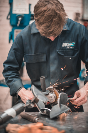 london, england, 02/02/2018, Young industrial metal working apprentice worker learning various metal working skills in an industrial factory setting. Apprentice schemes returning to england.のeditorial素材