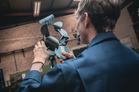 london, england, 02/02/2018, Young industrial metal working apprentice worker learning various metal working skills in an industrial factory setting. Apprentice schemes returning to england.のeditorial素材