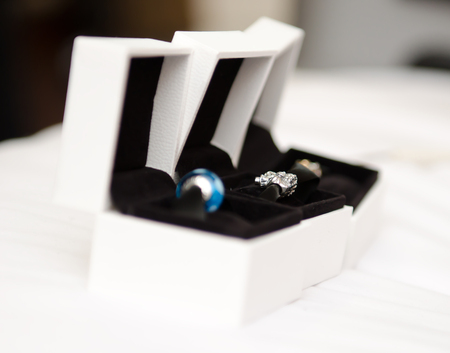 Wedding jewellery on a white soft surface, in white boxes , soft with a beautiful creamy shallow...