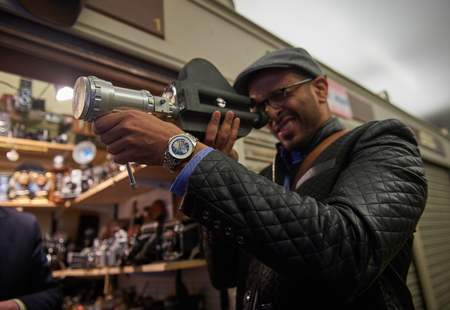 05/05/2017 A young arabic male tourist in london on the world famous carnaby street, looking and trying out retro film and movie cameras in an antique camera shop.のeditorial素材