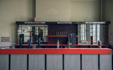 london, england, 05/05/2018 An abandoned old vintage bar pub in an art deco closed scary building. Forgotten history and past. Dated and out of fashion.のeditorial素材