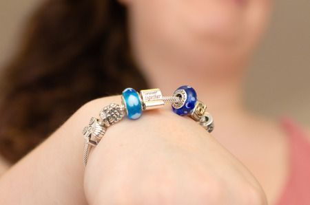 London, England,08/05/2018 beautiful aqua blue wedding friendship bracelet bangle jewellery, on a white womans hand. lucky good luck charms. wedding favours.のeditorial素材