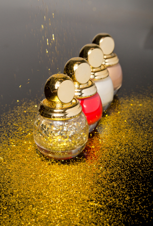 london, england, 05/05/2018 christian dior designer womans perfume bottles on a glass mirrored surface. expensive posh high quality women scented perfumes. golden bottle.のeditorial素材
