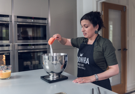 Lancashire, england, 05/05/2018  masterchef  2018 finalist moonira Hinglotwala, preparing food in a modern kitchen interior. home cooking, traditional indian cooking. television chef.のeditorial素材