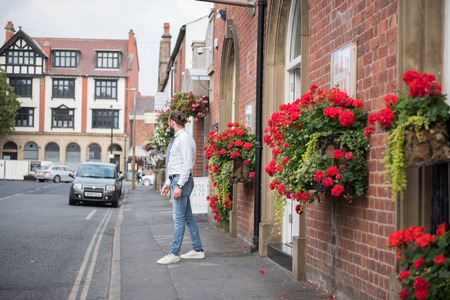 Lytham, England, 05/05/2018  Shops in lytham stannes in lancashire. Lytham high street shopping road. Up market gentrification. Red flowers outside a pub.のeditorial素材
