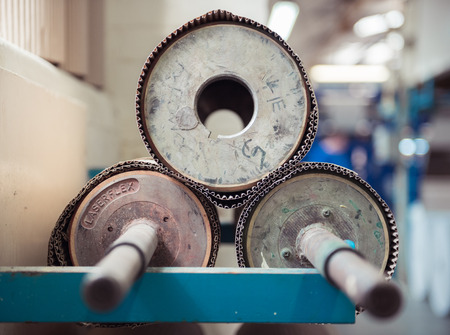 london, england, 05/05/2018 Beautiful metal industrial machinery steel cogs in a rustic industrial factory setting. Well used processing machinery parts.のeditorial素材