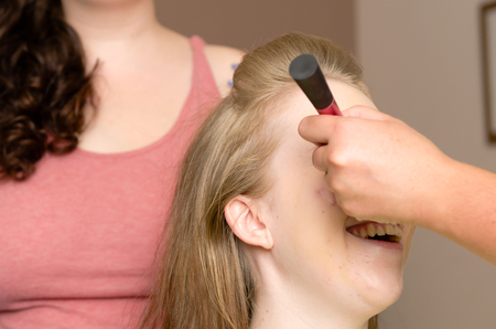 london, england, 05/05/2018 A woman getting her hair and makeup done before a wedding. Cosmetics and beauty industry lifestyle scene.のeditorial素材