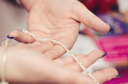 London, England,08/05/2018 beautiful aqua blue wedding friendship bracelet bangle jewellery, on a white womans hand. lucky good luck charms. wedding favours.のeditorial素材