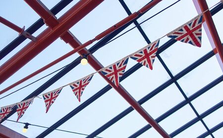 British union jack bunting , celebrating jubilee queens day. England pride, patriotic, vintage wartime english triangle bunting. Graphic flag symbolism.の写真素材