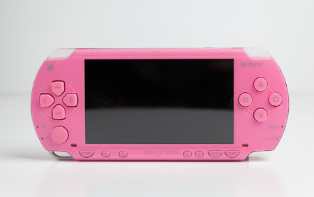 london, england, 05/05/2019 A pink sony playstation psp portable games console. pop 1001. Rare pink edition with blank screen isolated on a white background. retro vintage gamers computer console.のeditorial素材