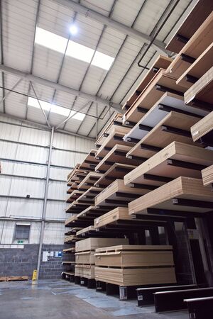 A large industrial racking in a woodworking diy factory,  holding and storing various wooden...