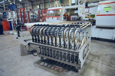 london, england, 05/02/2018 An automatic laminate edge trimming machine in a factory setting....