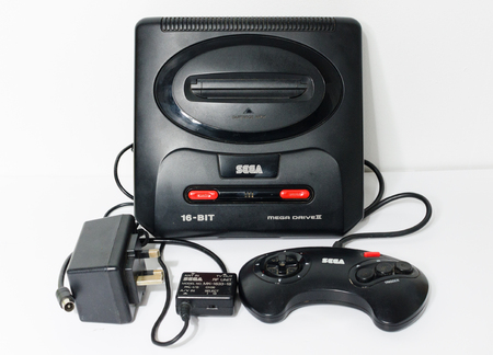 london, england, 05/05/2018 Sega megadrive 2 16 bit and Sega Mega drive 2 black shiny plastic retro arcade vintage gaming. Retro arcade gaming history. home entertainment.のeditorial素材