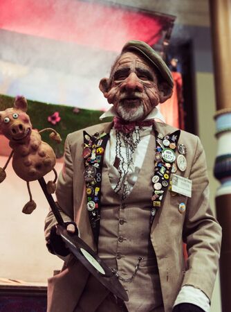 blackpool, england, 05/06/2019 A creepy face mask puppet master street entertainer in blackpool with a creepy scary dark evil puppet show to scare the children. Free street entertainment.のeditorial素材