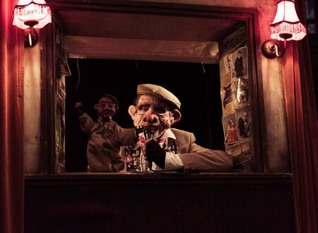 blackpool, england, 05/06/2019 A creepy face mask puppet master street entertainer in blackpool with a creepy scary dark evil puppet show to scare the children. Free street entertainment.のeditorial素材