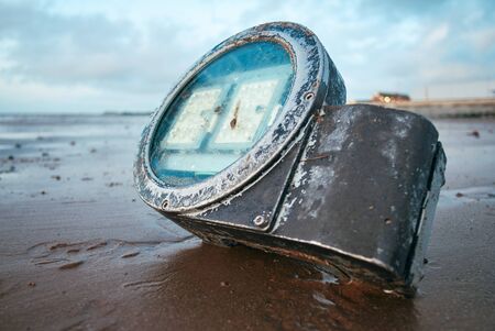 Metal industrial waste washed up on a sand and pebble beach. Environmental plastic pollution issue causing world  news. Health disaster on shores across the world.                              の写真素材