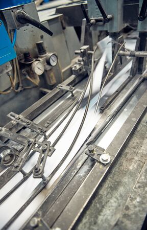 A industrial commercial envelope making machine, making paper envelopes for international...