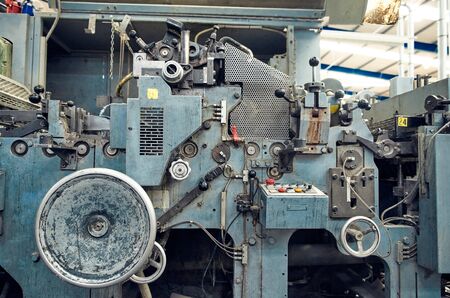 A toilet paper making machine, producing toilet and bathroom paper rolls due to Corona virus panic buying.  Paper and tissue manufacturers factory and engineered machinery.の写真素材