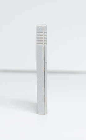 A dirty used old blank nintendo gameboy original video game cartridge 1990s famous iconic game boy portable classic video gaming on the move. Grey nintendo cart perfect for comping on other graphics and mock up.のeditorial素材