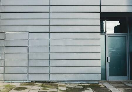 A dirty metallic futuristic dystopian urban wall in a city. Blank metal wall perfect for mock up and...
