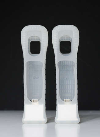london, england 05/052019 A pair of white Nintendo wii motion plus adaptors and silicone grips, on a...