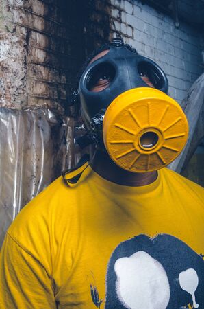 A black male with a military grade gas mask to protect himself from the corona virus covid19 pandemic. Face mask used to prevent the spread of the virus. Mandatory face coverings.の写真素材